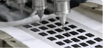 Grip material being applied to a sock sole