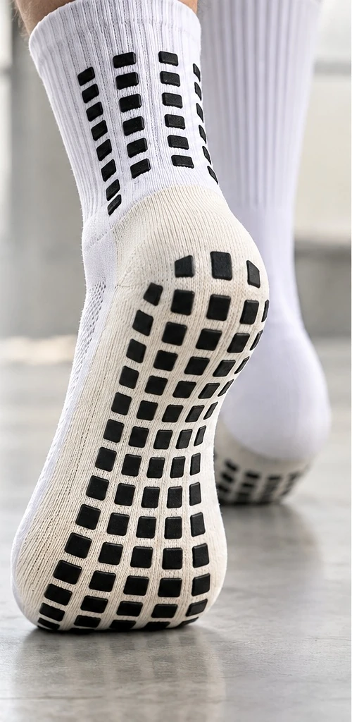 Close product view of a grip sock sole with a black rectangular grip pattern