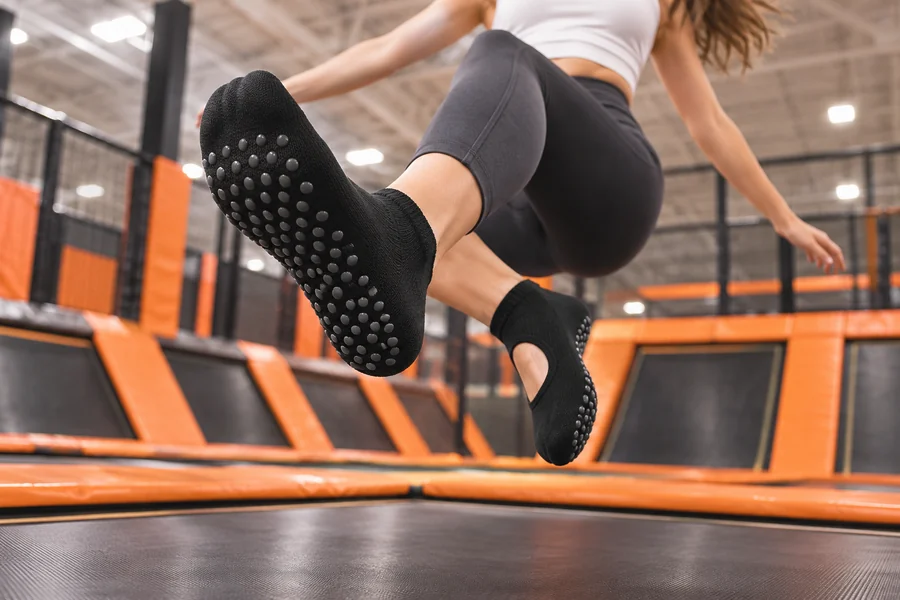 Black grip socks with visible sole grips in a trampoline park