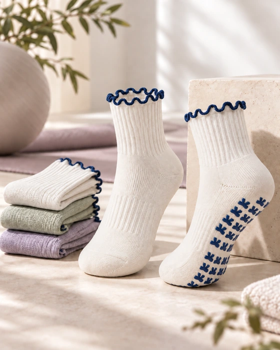 White scalloped-cuff studio grip socks with navy sole grips and folded seasonal colours